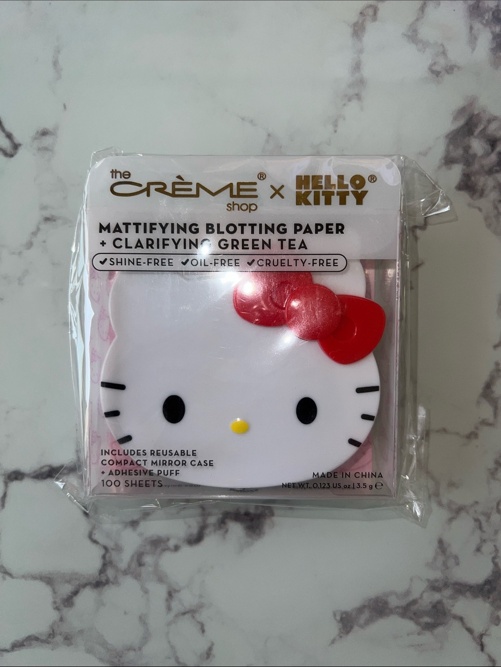 the Crème Shop x Hello Kitty Mattifying Blotting Paper - White with Red Bow